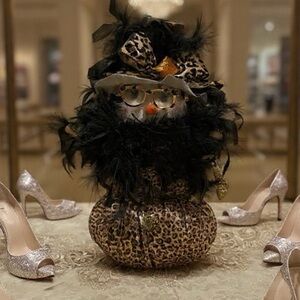 Chic Leopard Print Snowwoman with Black Feathers carrying Golden shoes